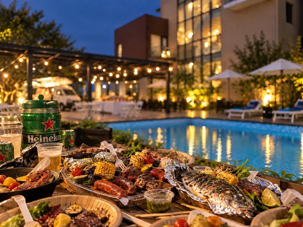 Grilled meat, seafood and string lights at an evening poolside gathering at LOHERB