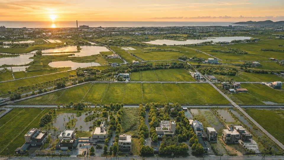 Aerial view of LOHERB Villa: Herb Villa Café and Tree Villa Lobby on the left, Flower Villa Restaurant to their right, with rice paddies stretching toward the coast behind.