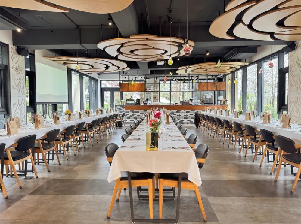 Long banquet tables set with food and flowers at Flower Villa Restaurant