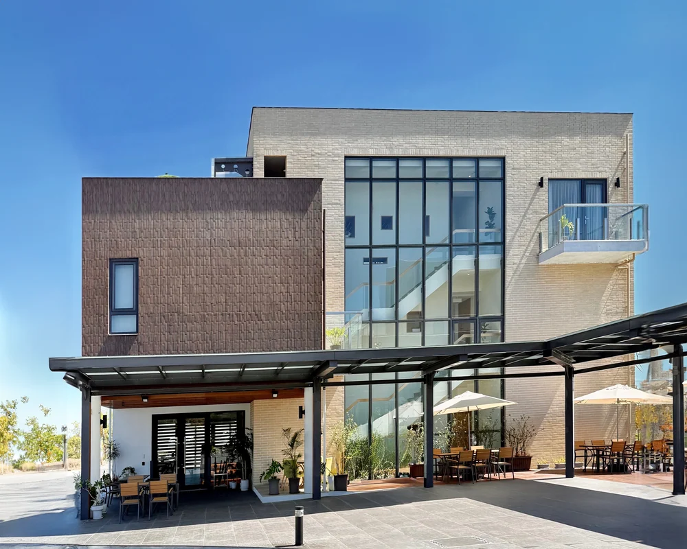 Herb Villa Café exterior with large windows and covered outdoor seating