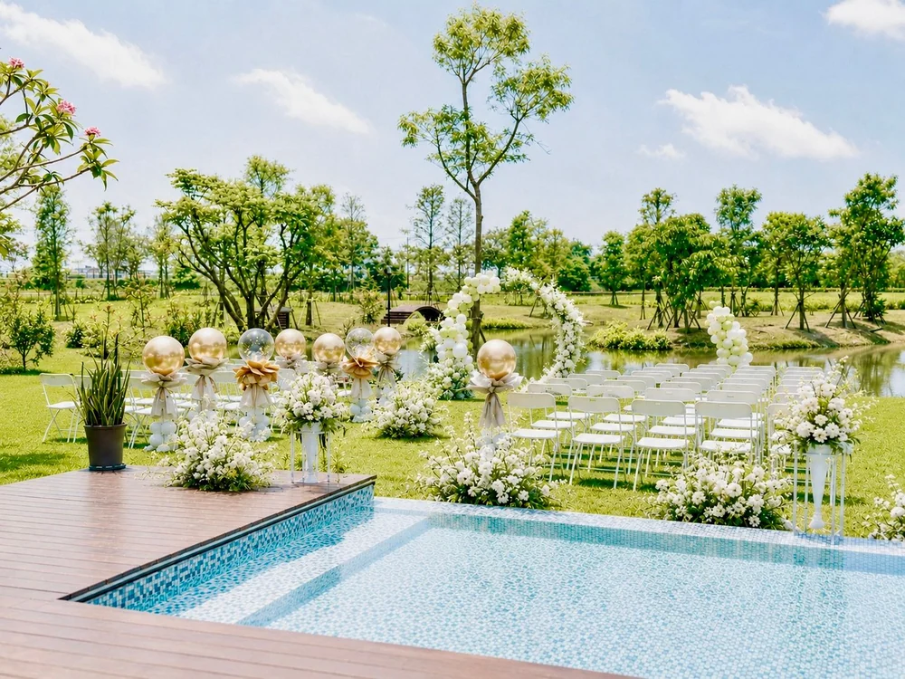 Floral arch and outdoor seating on the poolside lawn