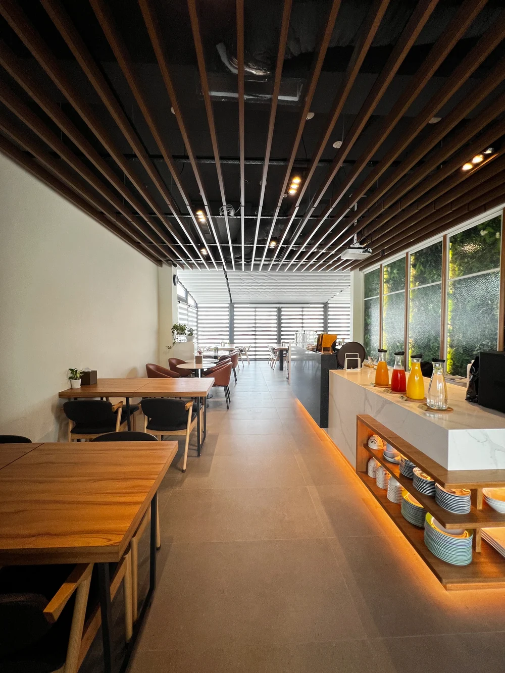 Wooden tables, chairs and drinks counter in the Herb Villa Café
